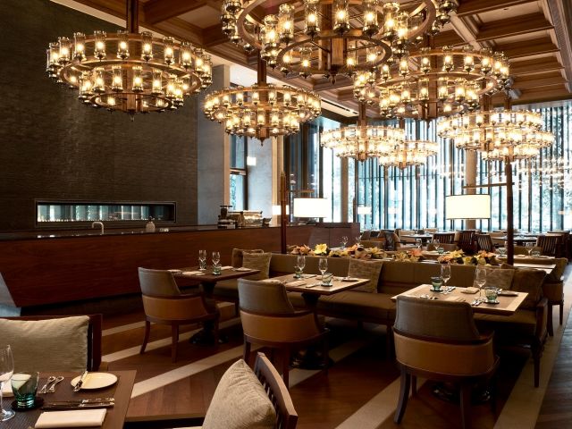 Dining area and bar inside the restaurant at the Chedi Andermatt in Swiss Alps.