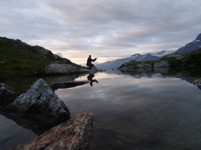 A Man Fishing In A Lake