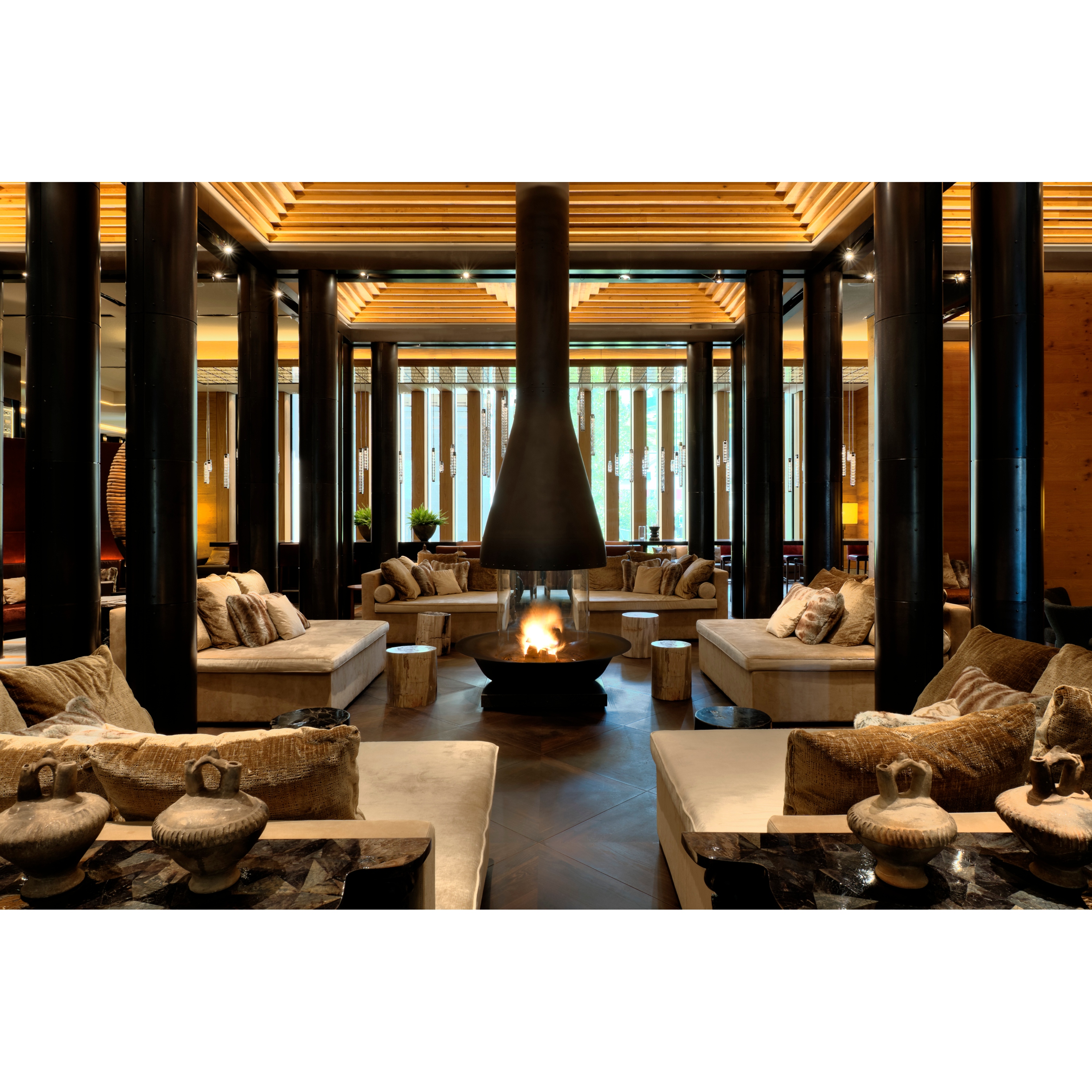 Seating area with fireplace at the lobby inside the Chedi Andermatt Swiss Alps.