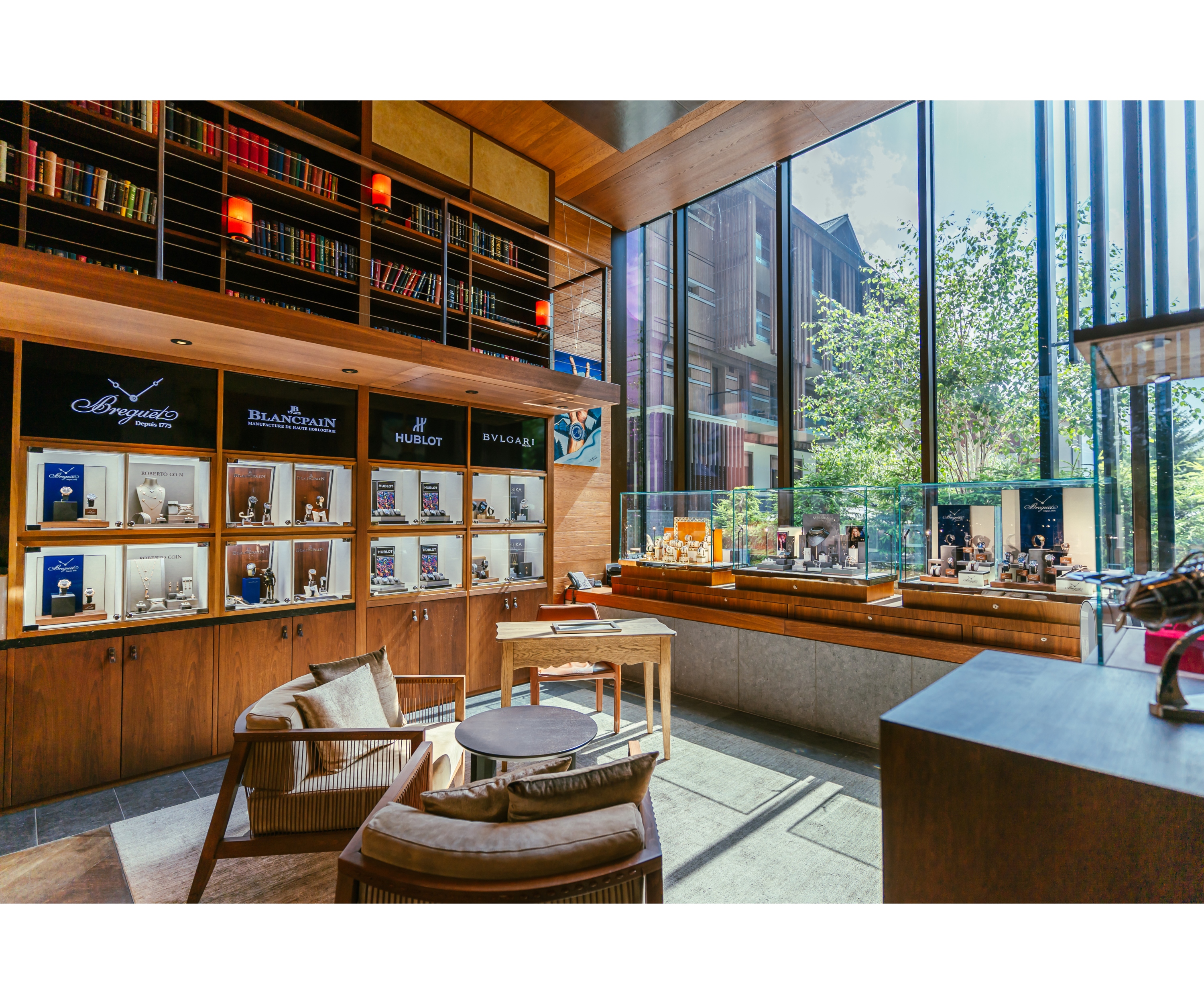 Bright room with large windows & showcases with watches, like in a jeweler's shop.