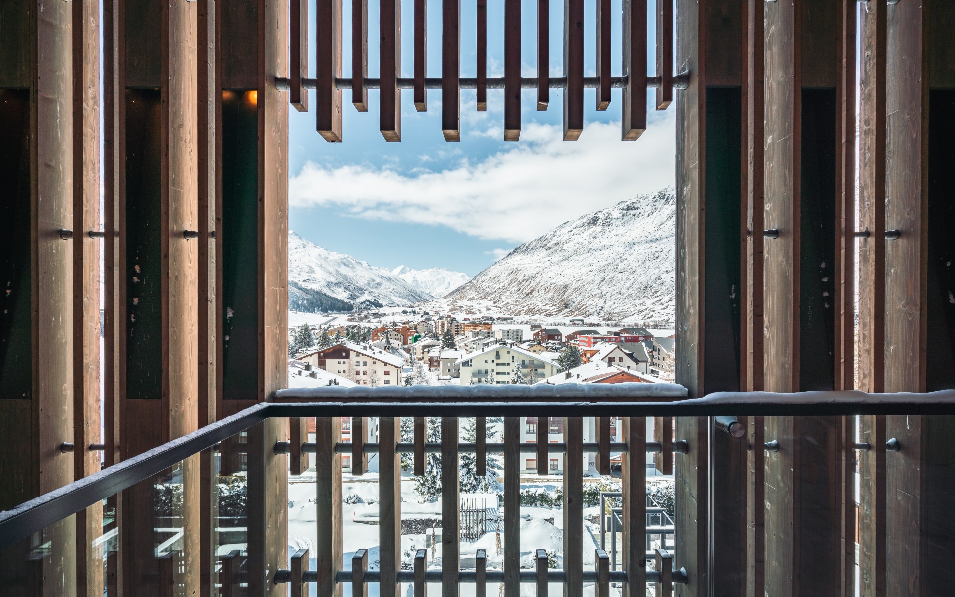 View of a balcony from the chedi on the village and the mountains in the background. Winter landscape.