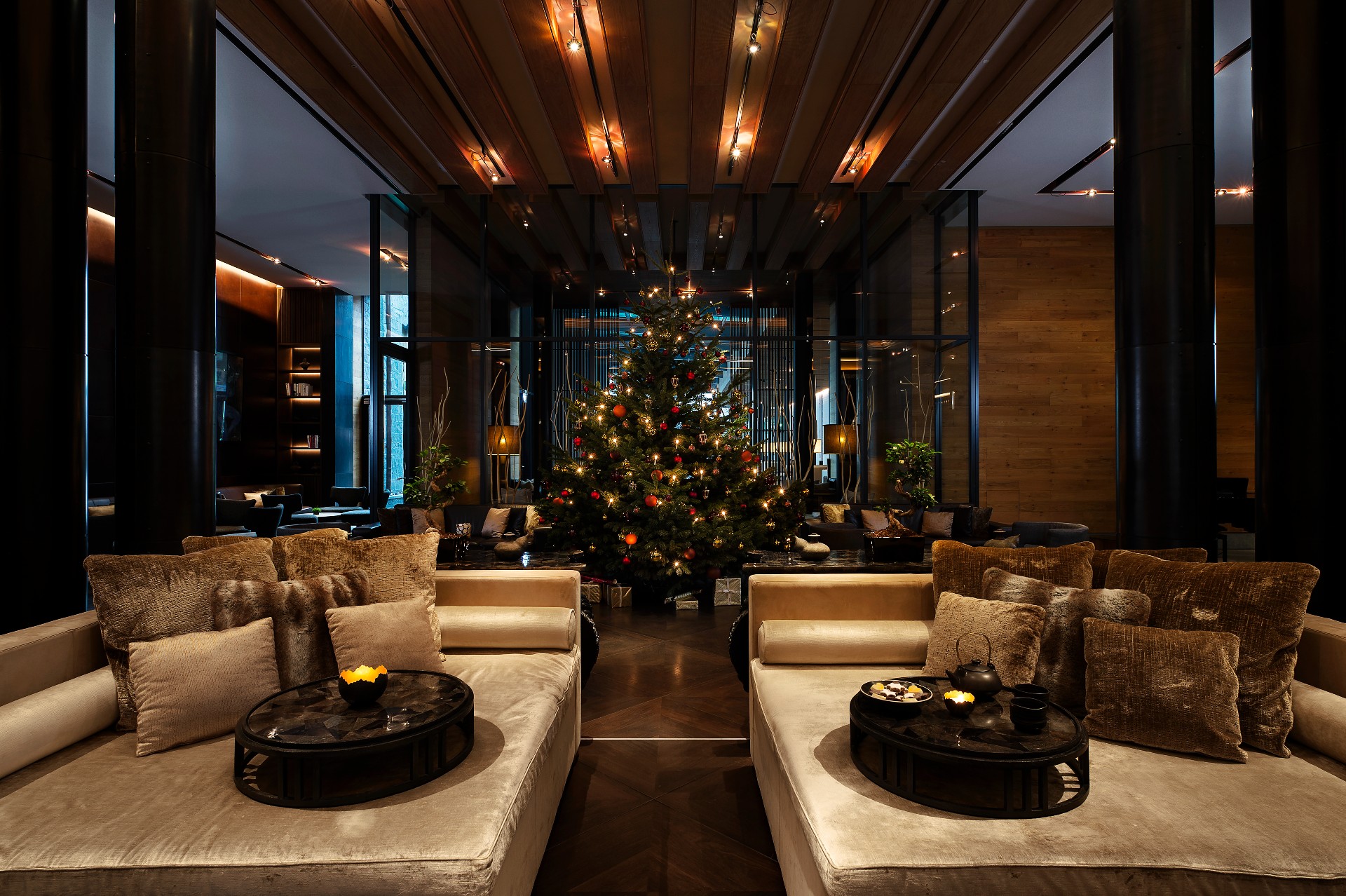 A Room With A Christmas Tree And Couches