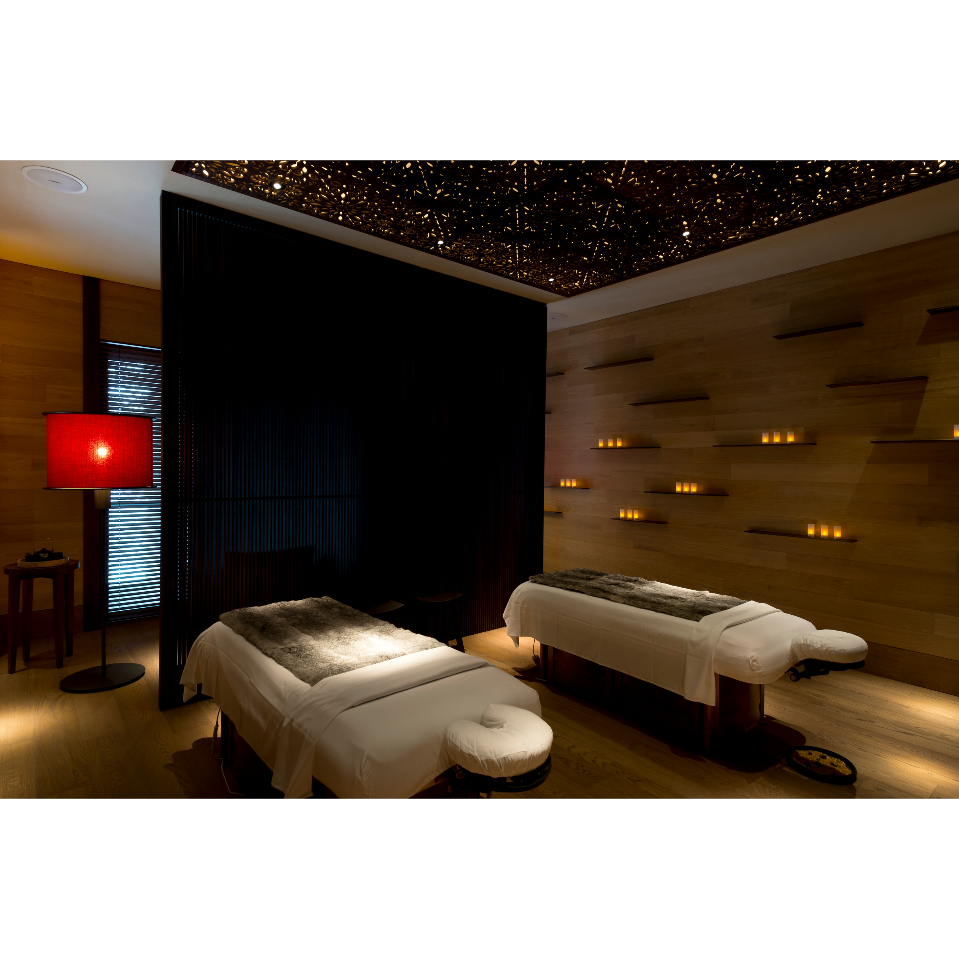 Massage room with two beds and warm lights at The Chedi Andermatt