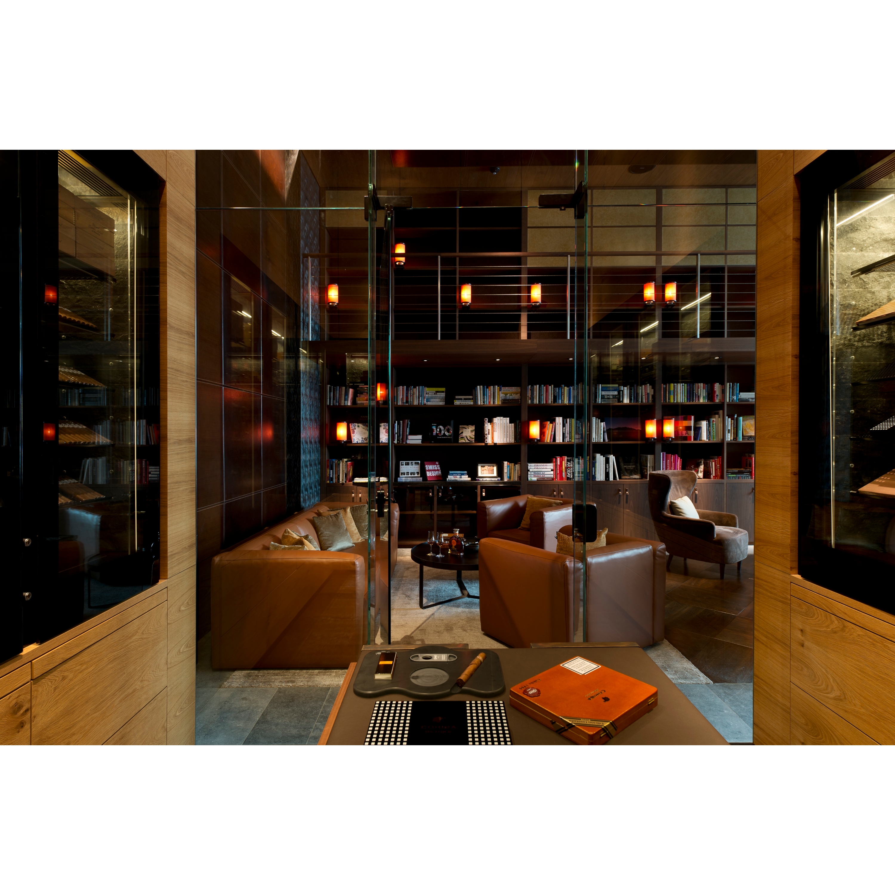 the cigar library seating area with book shelfs inside the chedi Andermatt hotel in Swiss Alps.