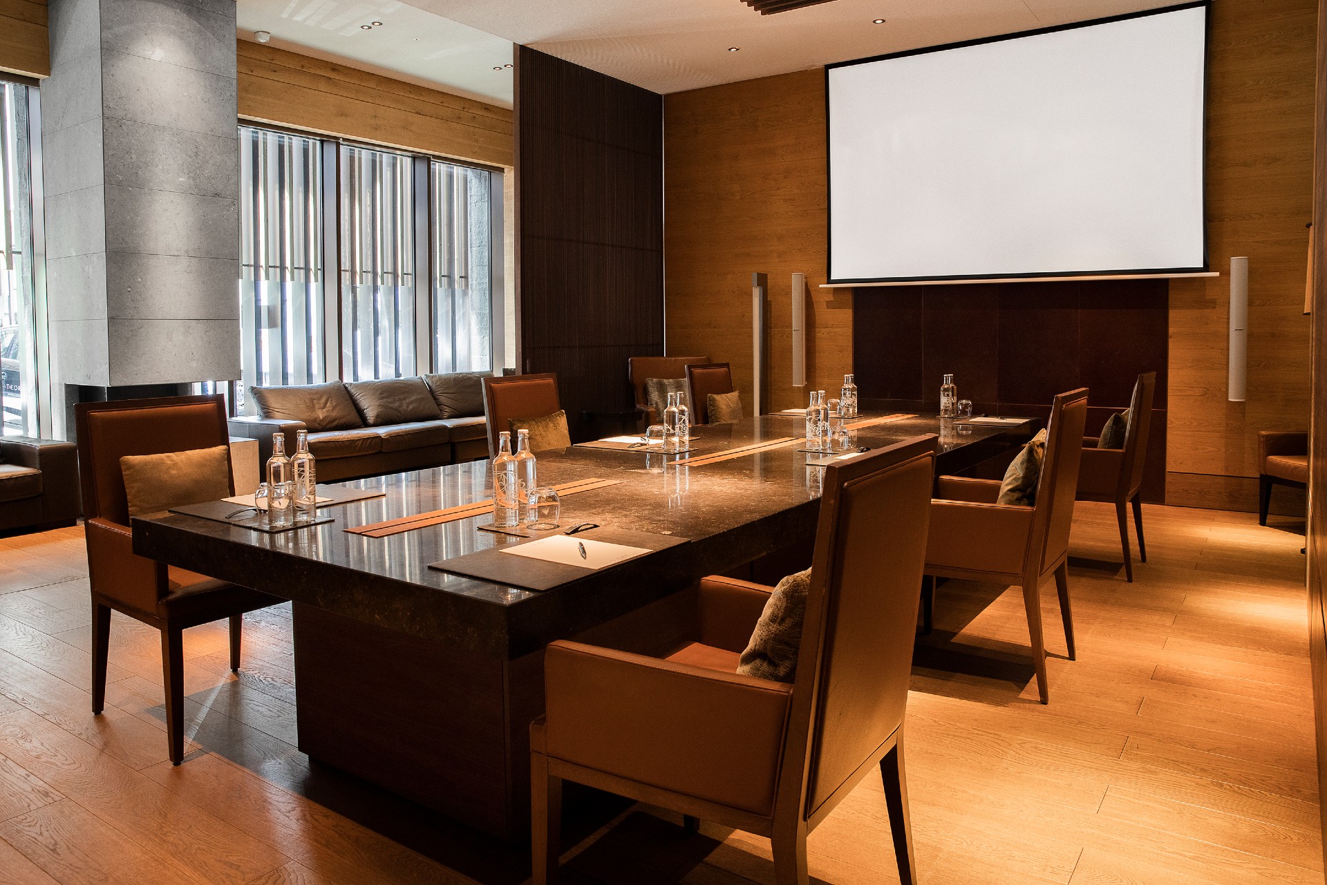 Meeting room at The Chedi Andermatt. A large marble table and elegant seating/furnishing.